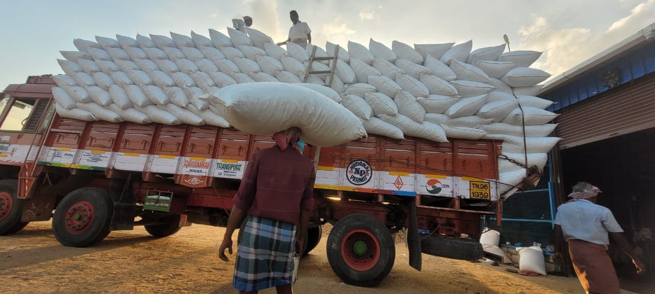 White sacks being loaded on truck